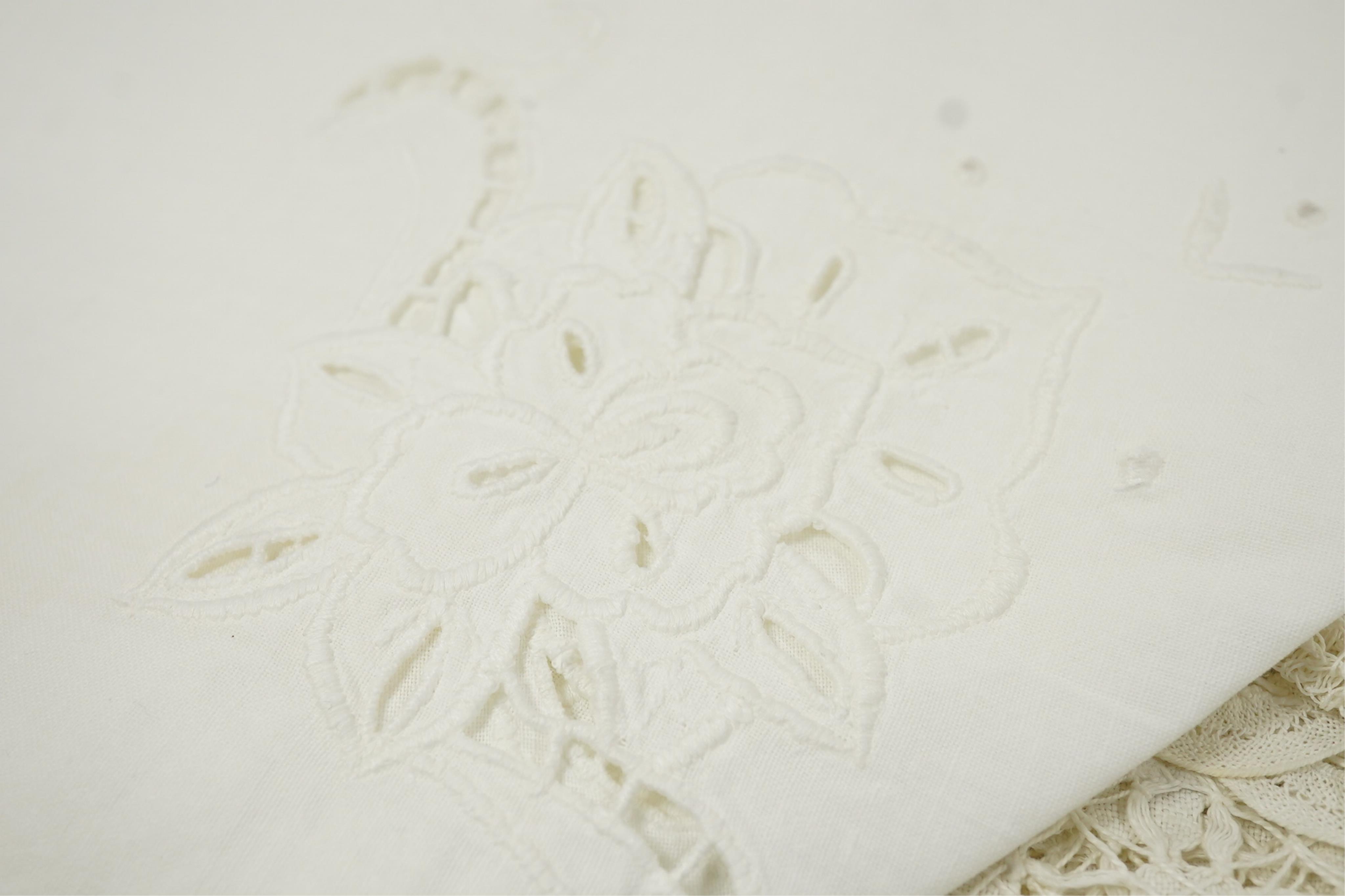 A collection of early 20th century and later crochet, cut work and drawn thread table linens and a large embroidered table cloth